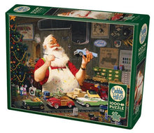 Load image into Gallery viewer, Santa Painting Cars - 1000 Piece Puzzle by Cobble Hill
